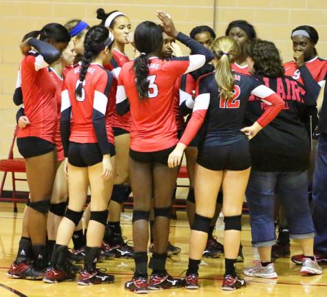 Lady Cardinals gather for a timeout huddle.